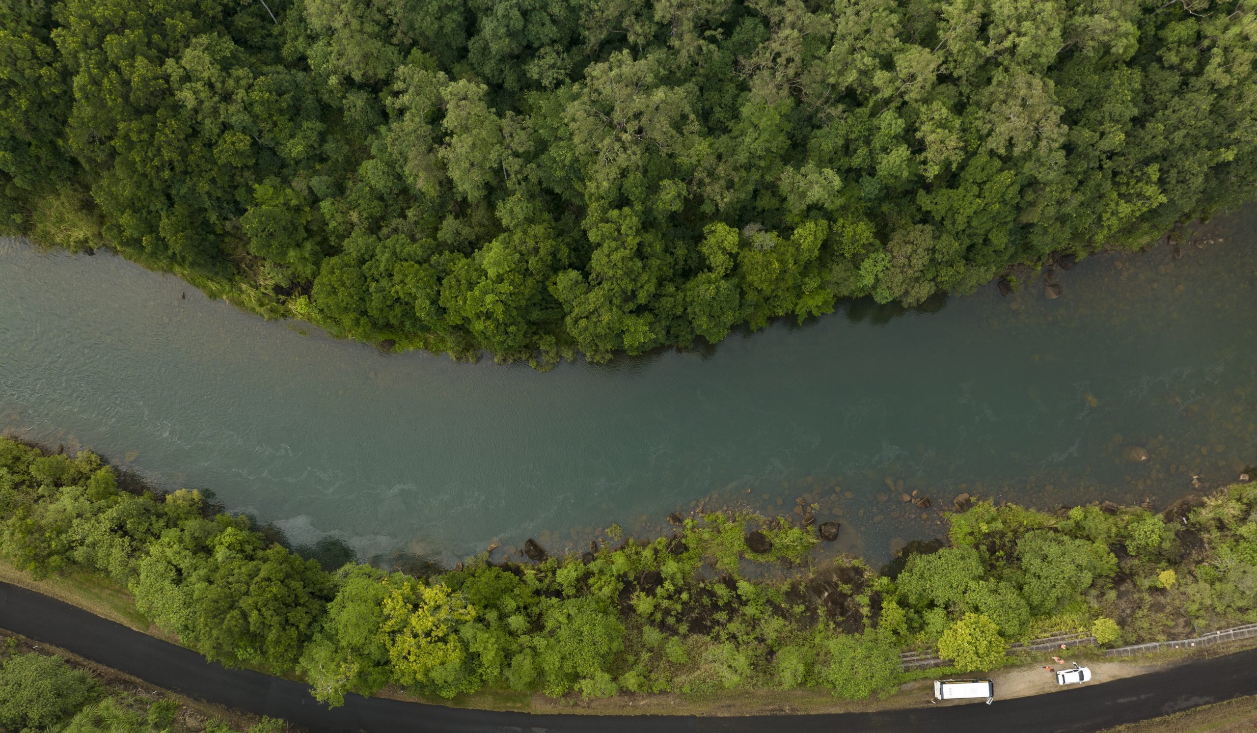 An aerial photograph of the Tully River with vegetation either side