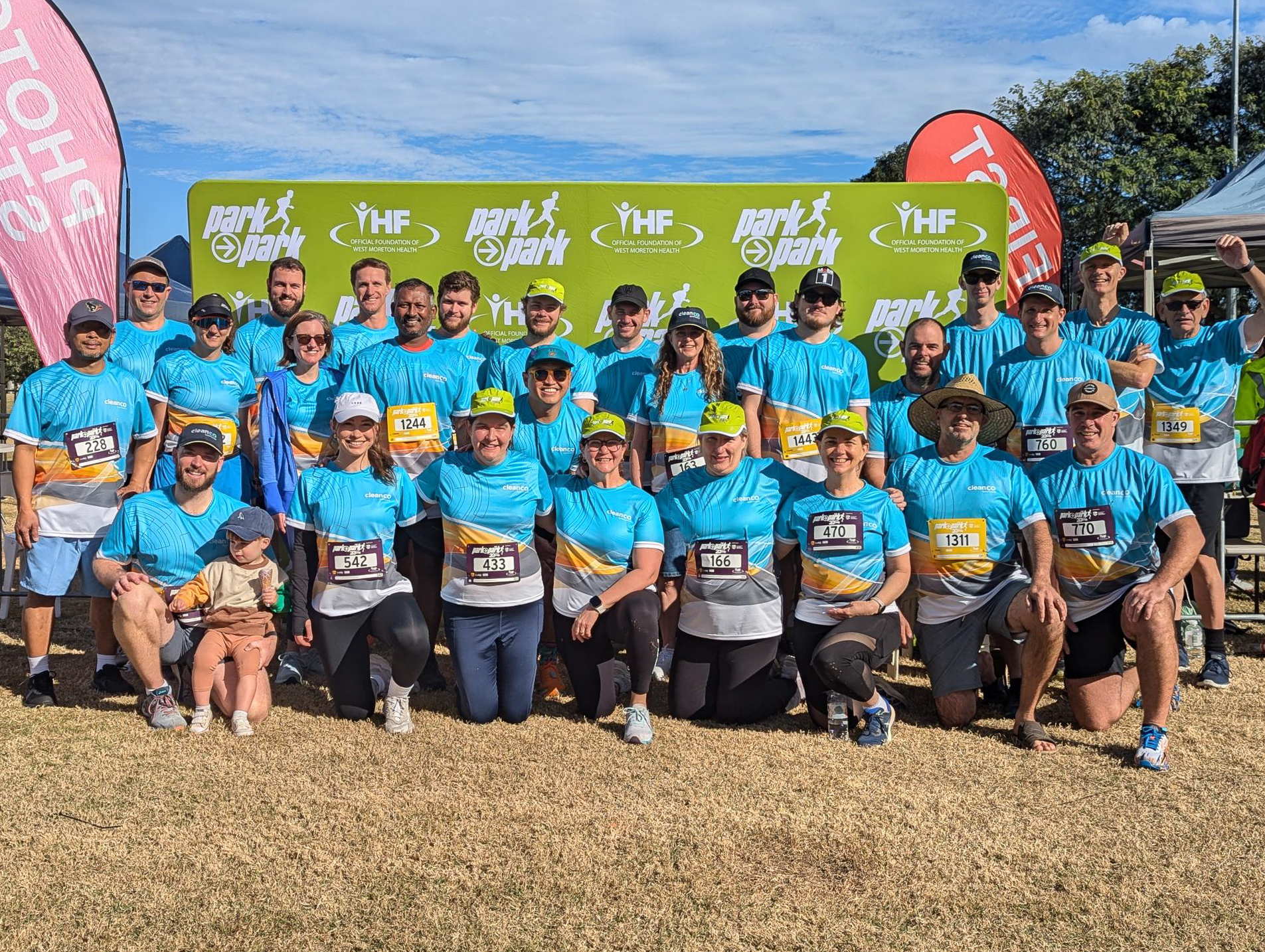 A large group of CleanCo employees wearing CleanCo branded sports shirts at the Ipswich Park2Park event in 2024