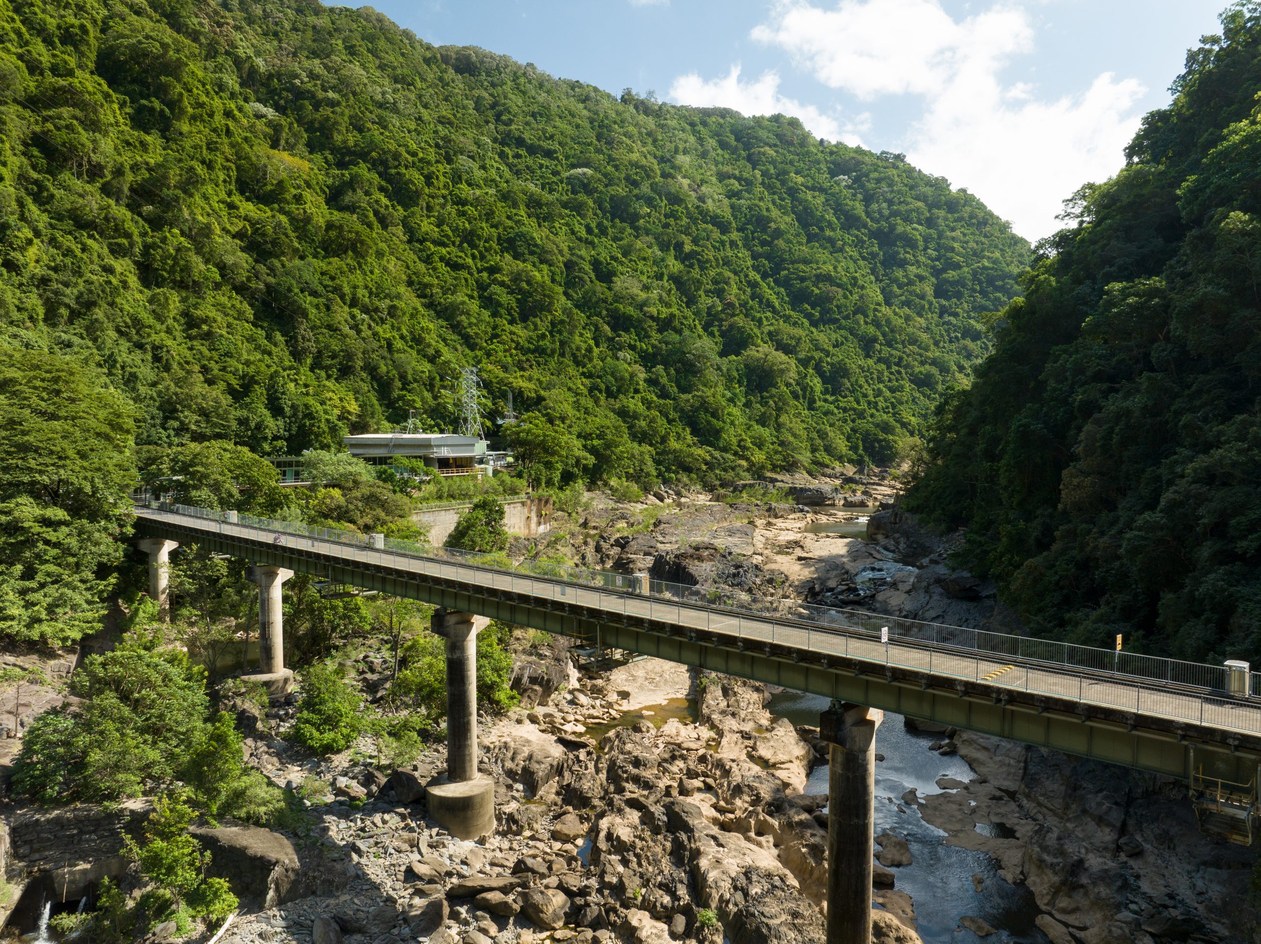 An expanded view of the Barron Gorge Power Station with a bridge in the foreground.