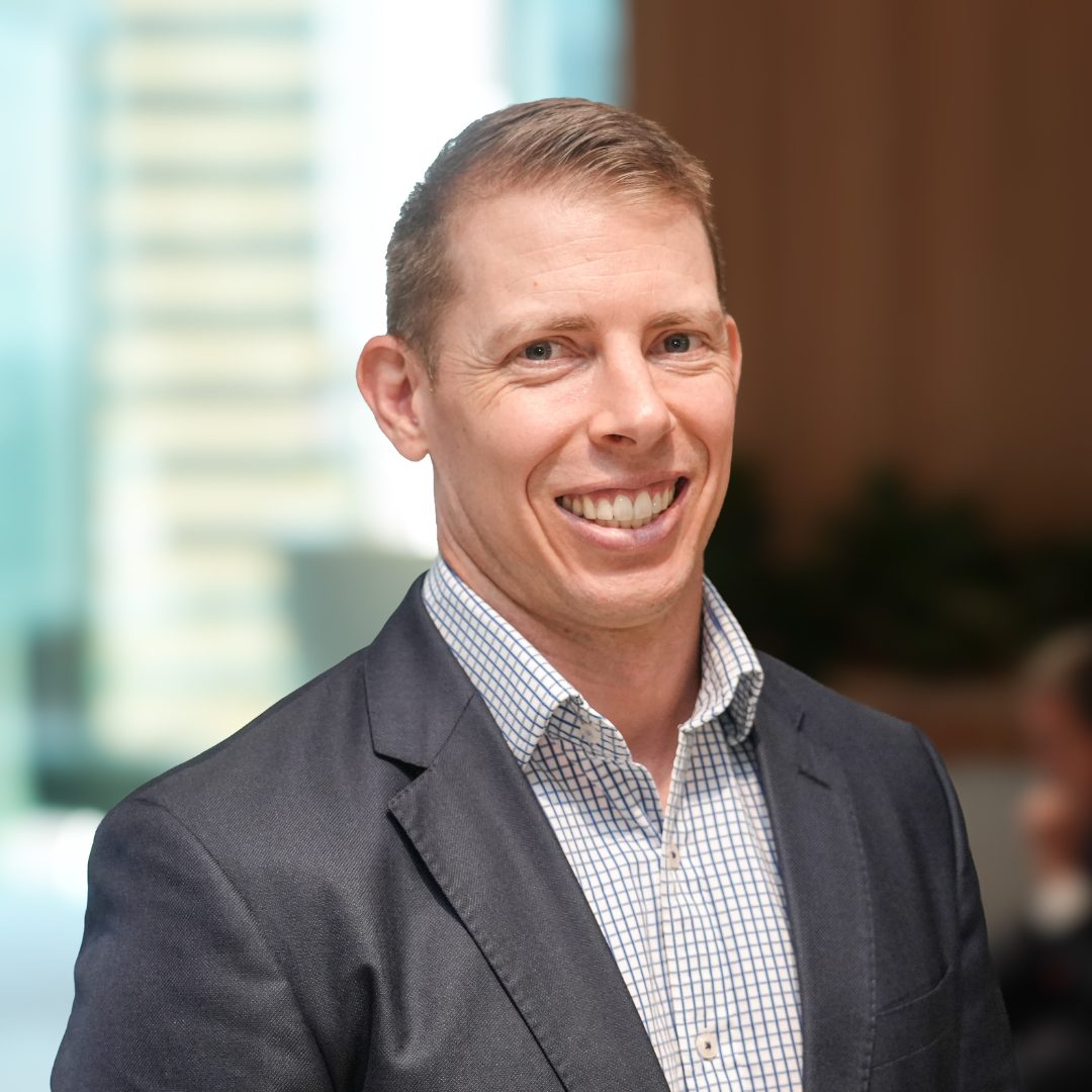 A photograph of Ben Jebb, CleanCo's Acting General Manager, Legal and Governance, smiling at the camera