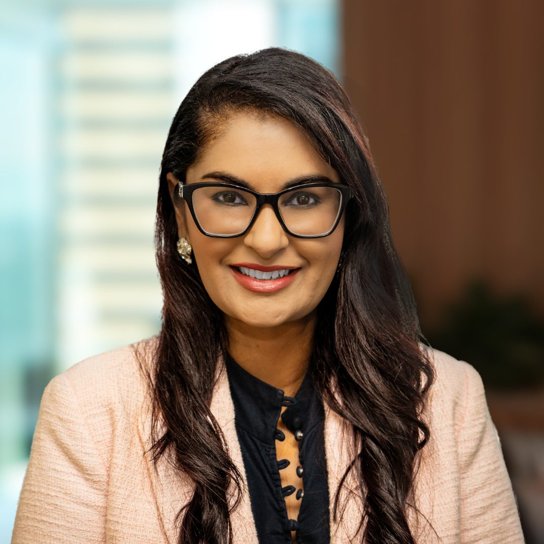 A photograph of CleanCo's Chief Information Officer, Karishma Darr, smiling at the camera