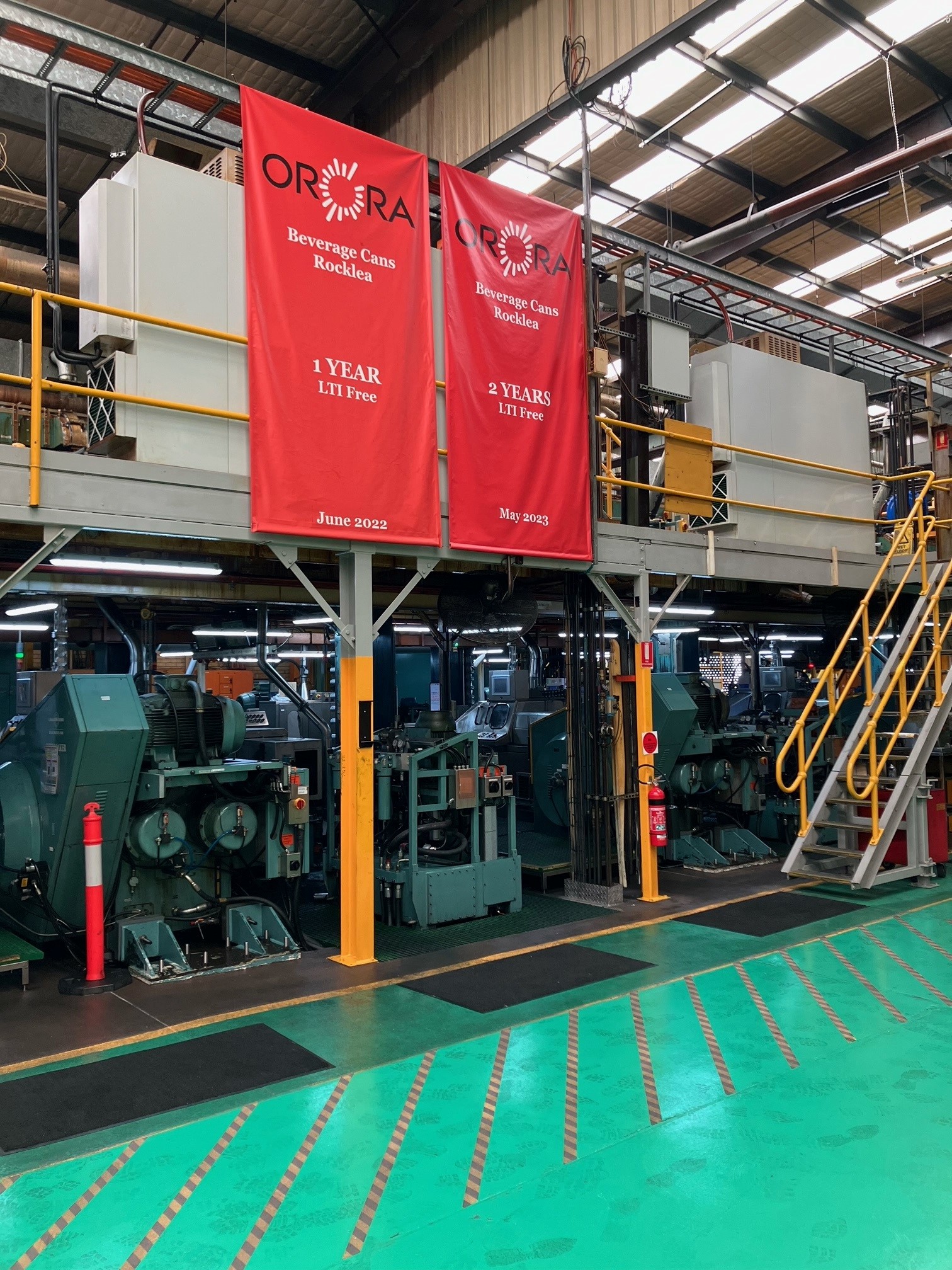 A photograph of flags inside the Orora manufacturing facility, celebrating the company's 12 months without a lost time injury