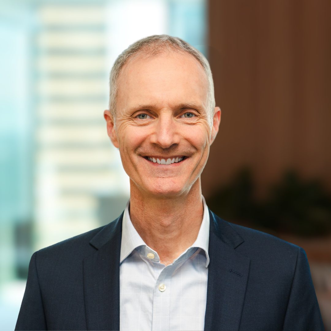 A photograph of CleanCo's Chief Executive Officer, Tom Metcalfe, smiling at the camera