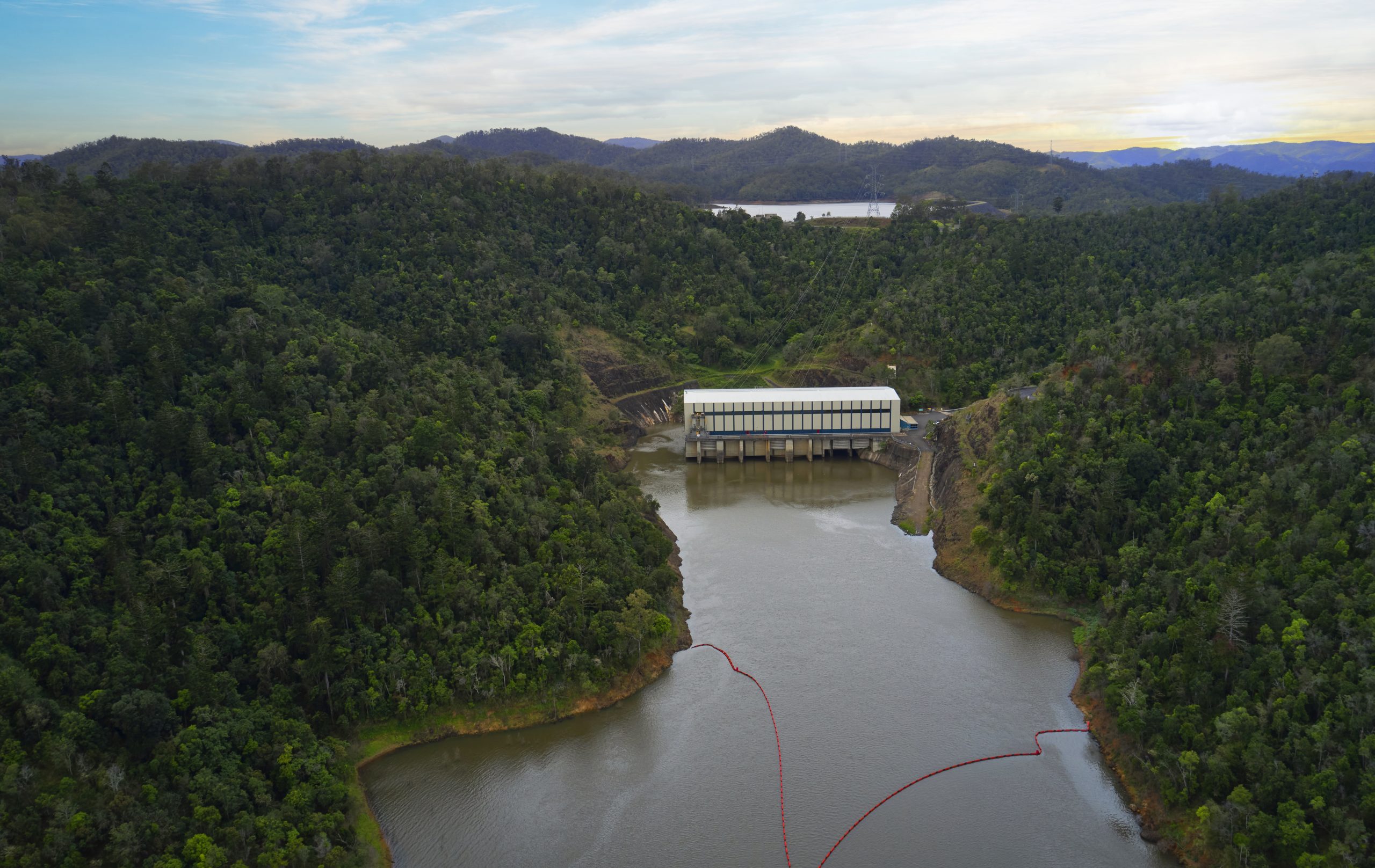 A photograph showing an aerial view of Wivenhoe Power Station in the foreground, while Splityard Creek Dam is in the background.