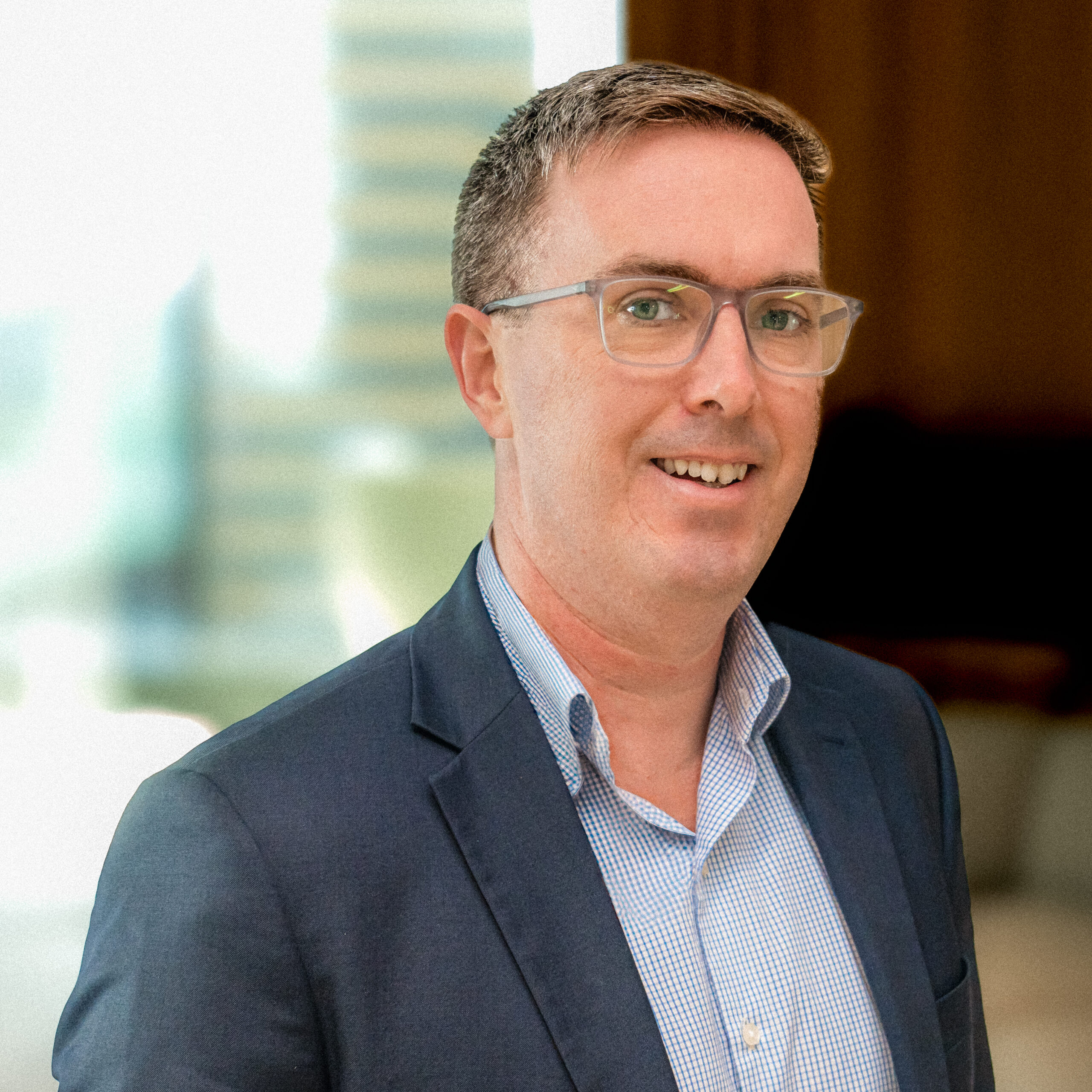 A colour photograph of CleanCo Chief Financial Officer, Brian Carrick, smiling at the camera
