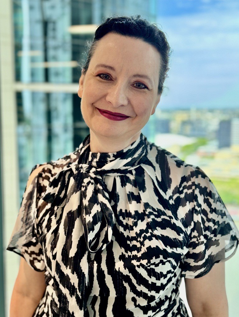 A photograph of a CleanCo legal team member, Kerry, smiling at the camera